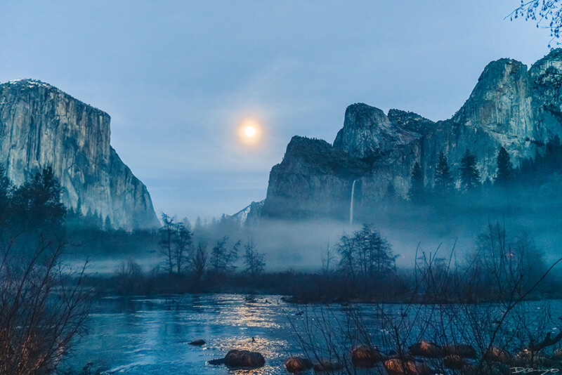 El Capitan and Bridal Veil Falls with a full moon and steam rising above the Merced River in Yosemite, CA