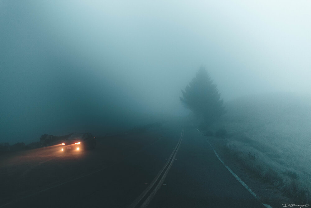 Orange Car Headlights in heavy teal fog in Misty Mt Tamalpais, CA