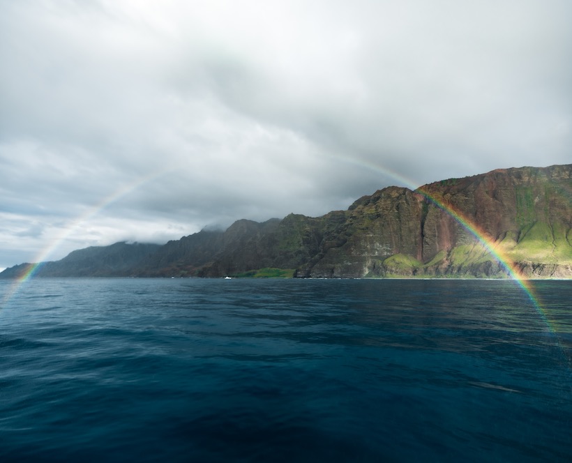 Na Pali Coast from the water with a rainbow in Kauai, HI