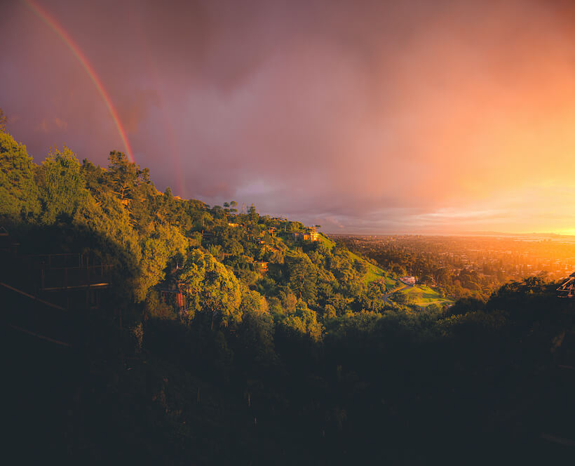 Golden sunset with double rainbow over the Berkeley Hills in the San Francisco Bay, CA
