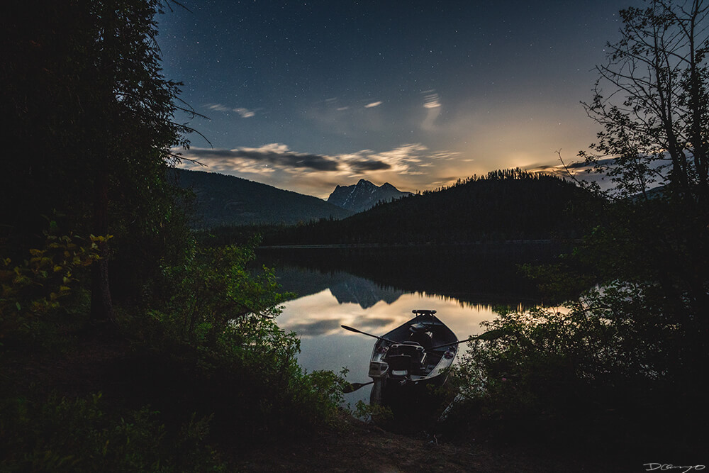 A rowboar on Bad Medicine Lake at night, Montana